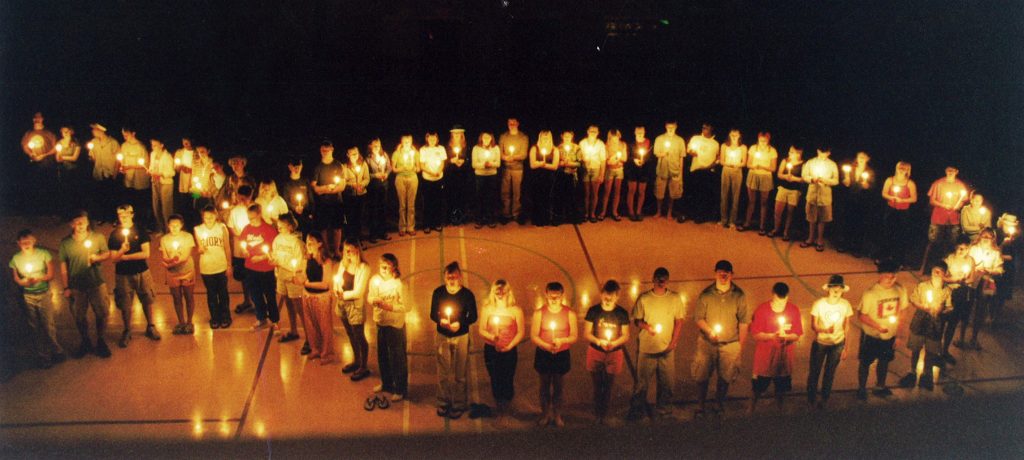 Teens with Candles Making the Shape of a Fish